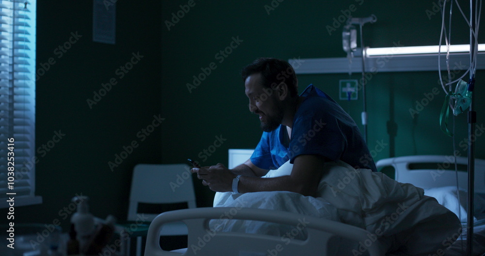 Sick guy on a hospital bed, chatting on his phone. Sick guy on a hospital bed, chatting on his phone.