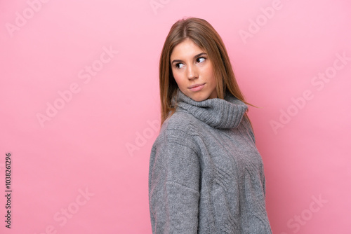 Young caucasian woman isolated on pink bakcground . Portrait photo