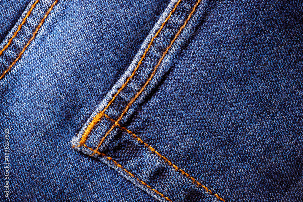 Worn denim trousers. Machine stitch close up. Denim texture in blue. The concept of repairing old clothes. Sewing factory. Fashionable aging clothes. Worn denim trousers. Machine stitch close up. Denim texture in blue. The concept of repairing old clothes. Sewing factory. Fashionable aging clothes.