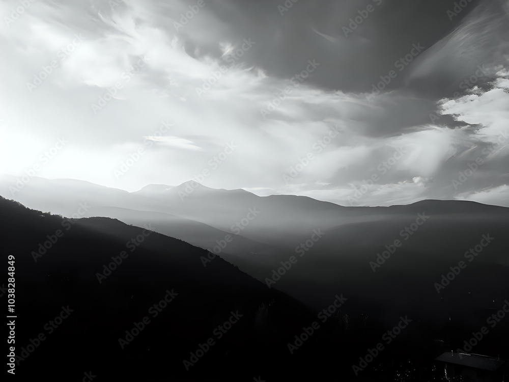 Fototapeta premium A majestic mountain over the hills, surrounded by clouds and a vibrant sky, the sun rises, showcasing the natural beauty and power of this impressive landscape.