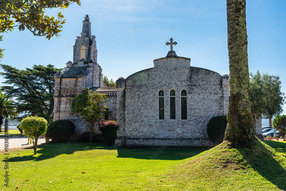 Fototapeta premium Church of San Sebastian covered in seashells on the island of La Toja, Galicia.