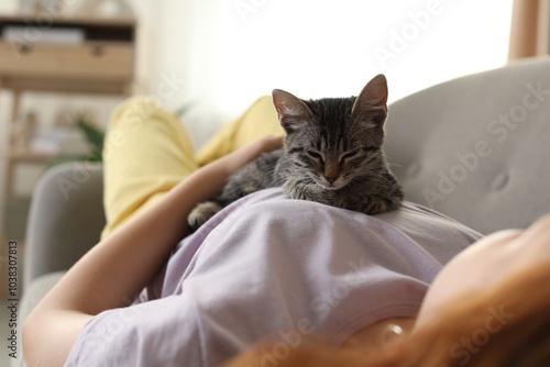 Wallpaper Mural Teenage girl with cute cat on sofa at home, closeup Torontodigital.ca