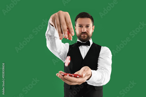 Photos Professional croupier with casino chips on green background