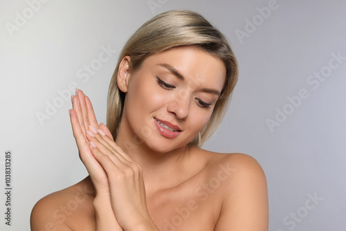 Cosmetology. Beautiful woman with perfect skin on grey background