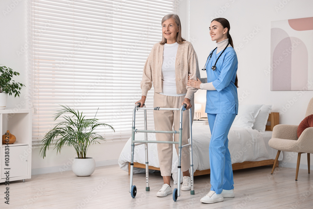 Nurse helping senior woman with walking frame in clinic Nurse helping senior woman with walking frame in clinic