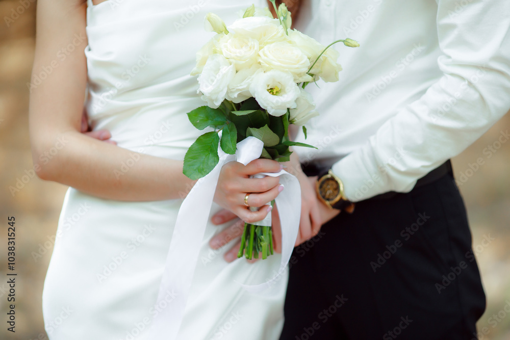 Wedding bouquet in the hands of the bride at the ceremony. Touching the hands of the bride and groom. Wedding jewelry. Wedding rings. The tenderness and beauty of the wedding ceremony. Wedding bouquet in the hands of the bride at the ceremony. Touching the hands of the bride and groom. Wedding jewelry. Wedding rings. The tenderness and beauty of the wedding ceremony.