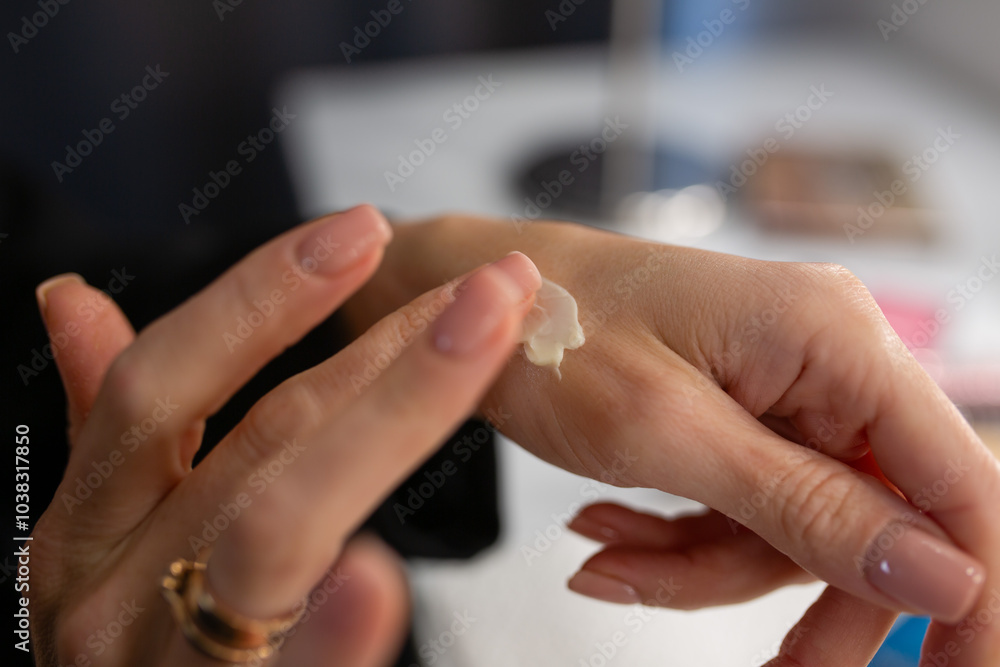 Close-up of woman's hands applying moisturizer to skin. Skin care concept. Close-up of woman's hands applying moisturizer to skin. Skin care concept.