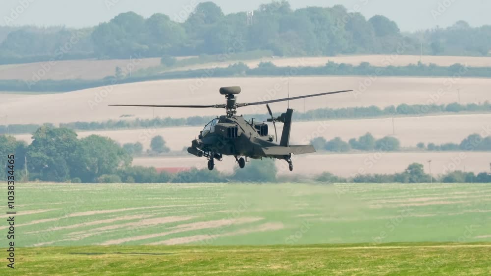 British army Boeing Apache Attack helicopter gunship AH2 AH64E AH-64E Army Air Corps in low level hover and flight, Wiltshire UK British army Boeing Apache Attack helicopter gunship AH2 AH64E AH-64E Army Air Corps in low level hover and flight, Wiltshire UK