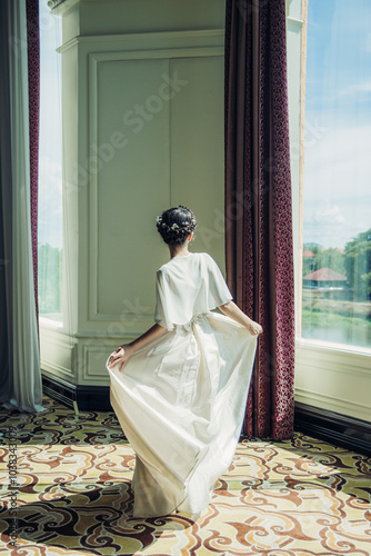 A moment of grace, elegance, and poise, bathed in the soft glow of natural sunlight.