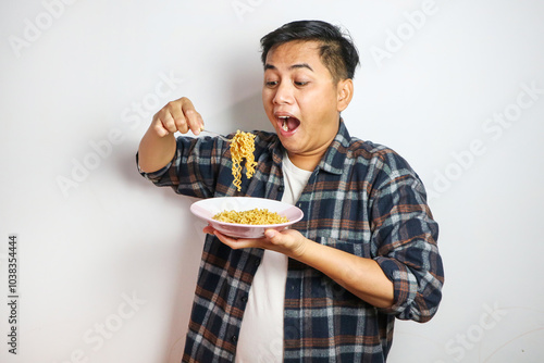 Wow and surprised funny face of Asian man eat instant noodle.