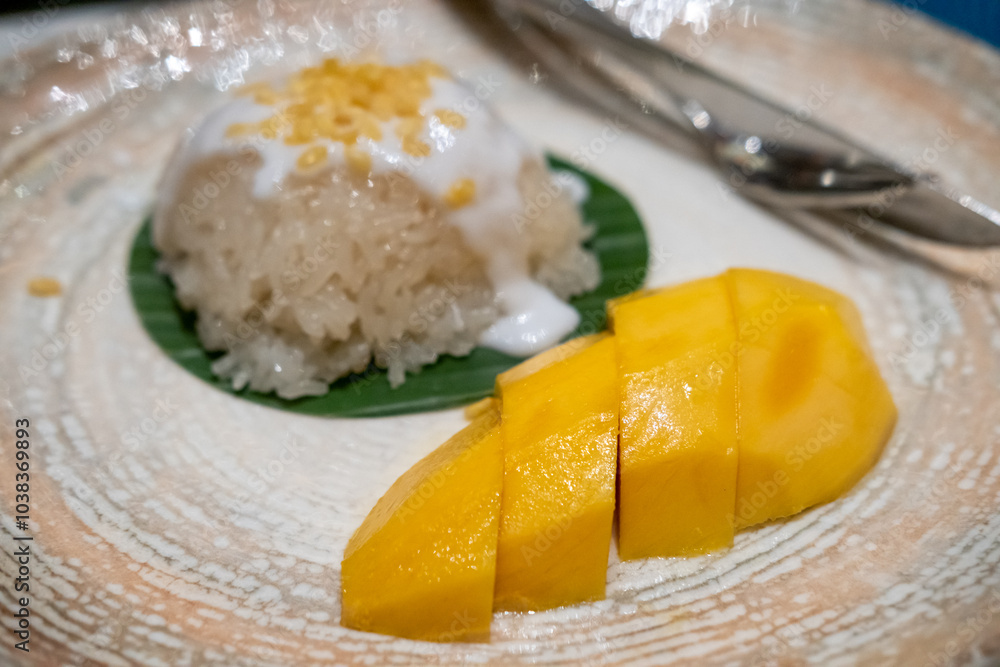 Mango sticky rice served on plate. It is a famous Thai dessert dish Mango sticky rice served on plate. It is a famous Thai dessert dish