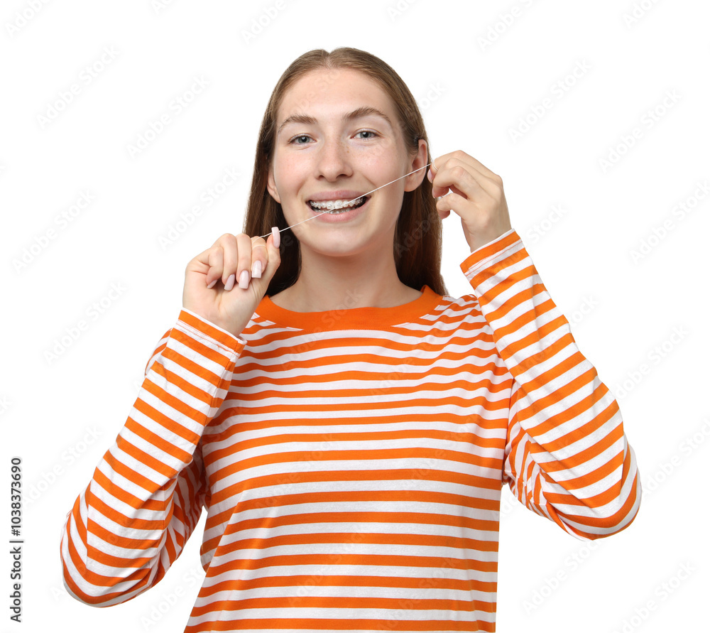 Smiling girl with braces cleaning teeth with dental floss on white background Smiling girl with braces cleaning teeth with dental floss on white background
