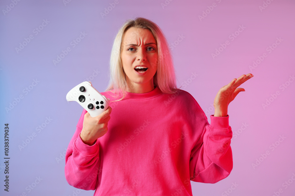Unhappy woman with controller on color background Unhappy woman with controller on color background
