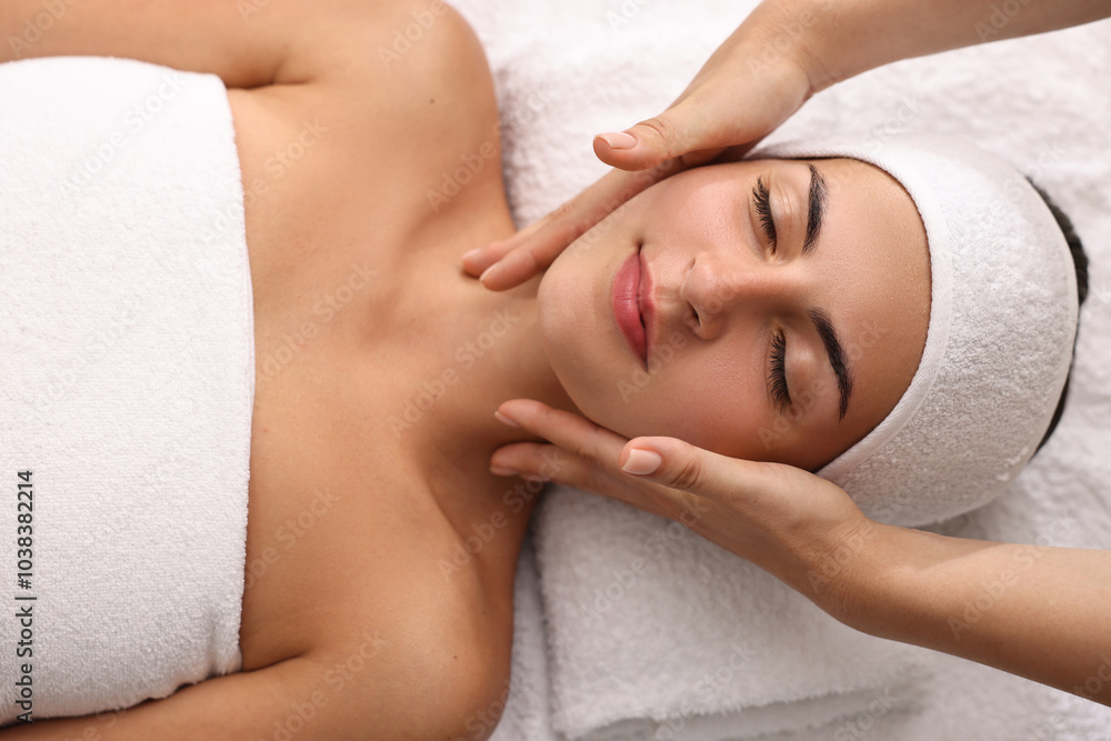 Attractive woman enjoying face massage, top view. Beauty procedure Attractive woman enjoying face massage, top view. Beauty procedure