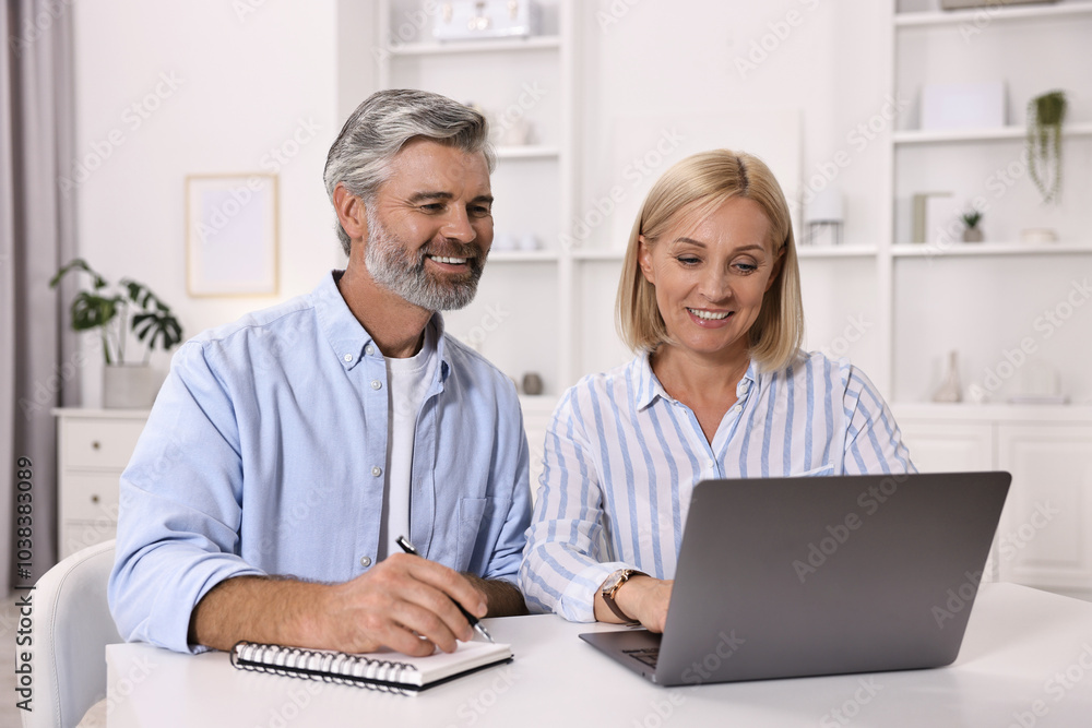 Pension savings. Couple planning budget at table indoors Pension savings. Couple planning budget at table indoors