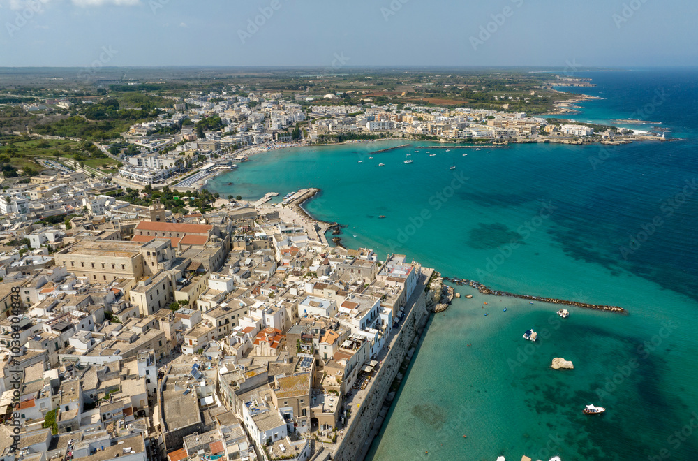 Fototapeta premium Aerial view of the historic center of Otranto in the province of Lecce, Salento, Puglia, Italy. You can see the cathedral of the town and in the background the Mediterranean Sea.