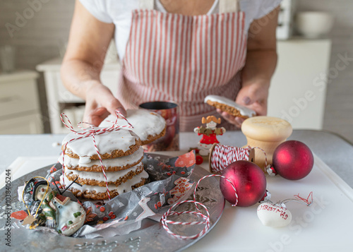 Homemade christmas gingerbread cookies fresh decorated by a woman in the kitchen. Traditional german elisen gingerbread photo