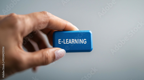 E-learning is modern educational approach that enhances learning experiences. This showcases hand holding vibrant blue block labeled E LEARNING, symbolizing digital education