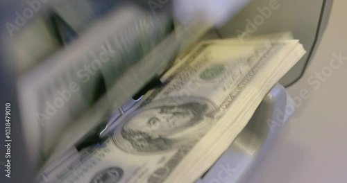 High quality video 6k 4:2:2 10bit downscale 4k .100 dollar bills counted in money counting machine. Cash money dollars into banknote counter. 