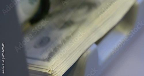 100 dollar bills counted in money counting machine. Cash money dollars into banknote counter. High quality video 6k 4:2:2 10bit downscale 4k 