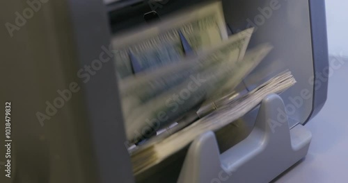 High quality video 6k 4:2:2 10bit downscale 4k .100 dollar bills counted in money counting machine. Cash money dollars into banknote counter. 