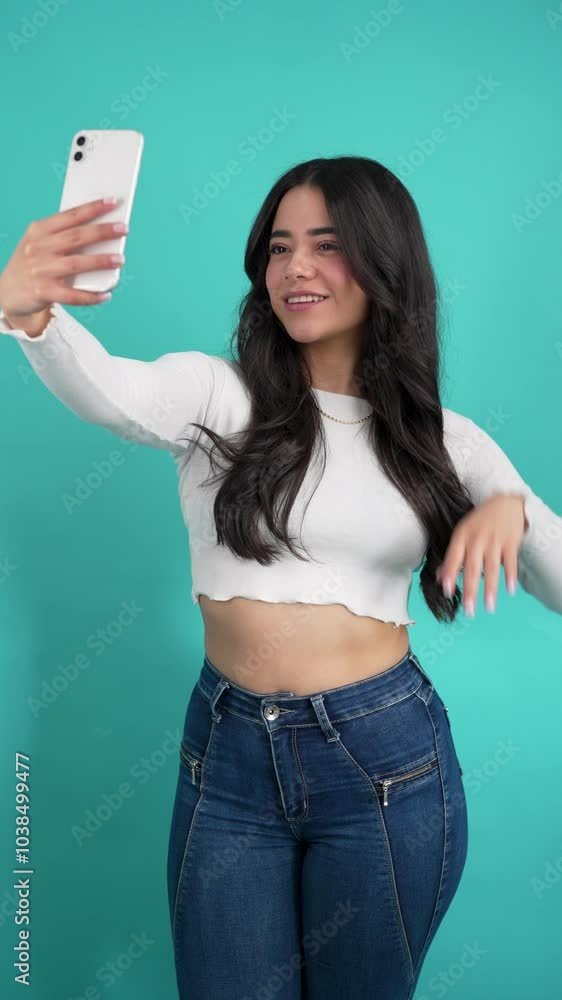 beautiful happy playful latin woman taking selfie in studio beautiful happy playful latin woman taking selfie in studio