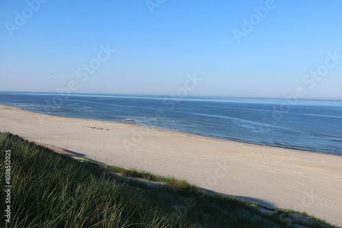 beautiful view from a high dune onto a deserted North Sea beach