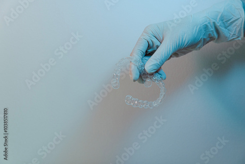 Doctor hand holding transparent aligners, dental care concept  