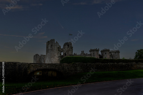 A comet in the night sky over Raglan Castle in Monmouthshire, Wales photo