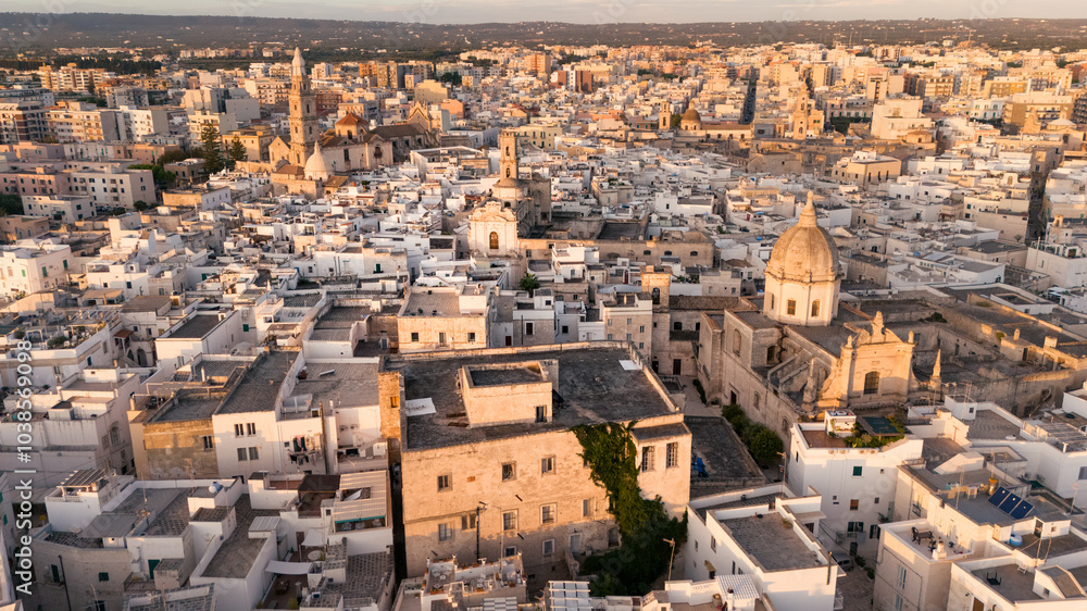 Obraz premium Aerial view ancient mediterranean town, houses church bell tower at sunrise, Monopoli, Puglia, Italy