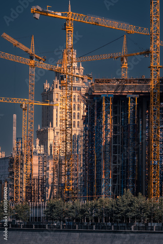Photography Lots of scaffolding and cranes at construction site of tall city building, Mosco