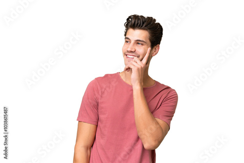 Young handsome caucasian man over isolated background thinking an idea while looking up