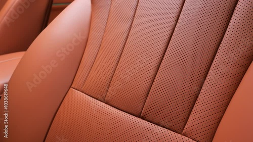 Orange interior of a premium car. Terracotta trim inside the car interior. Modern technologies