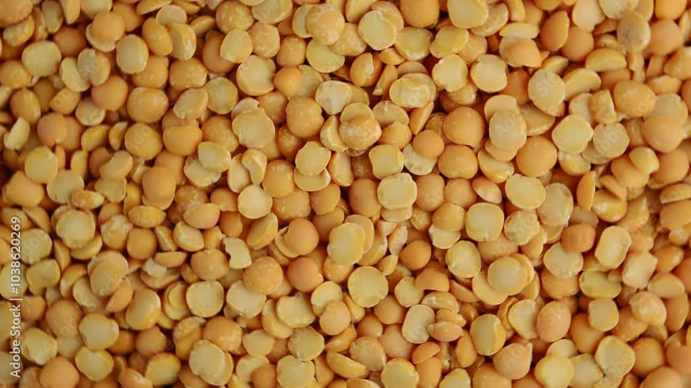 A round yellow pea rotates. Raw yellow peas. View from above. A round yellow pea rotates. Raw yellow peas. View from above.