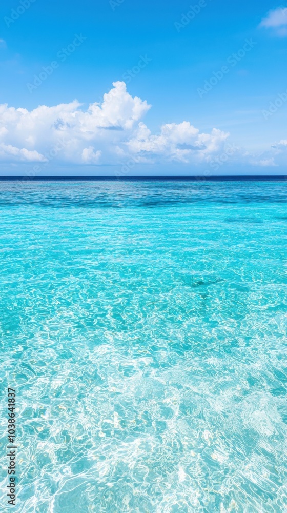 Crystal clear water under a bright blue sky with fluffy clouds. Crystal clear water under a bright blue sky with fluffy clouds.