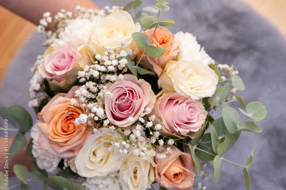 Wedding beautiful bouquet of roses in the hands of the bride, wedding rings Wedding beautiful bouquet of roses in the hands of the bride, wedding rings