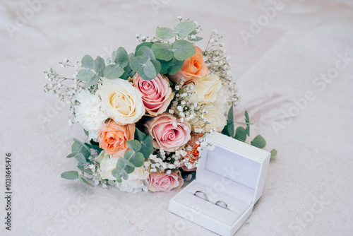 Wedding beautiful bouquet of roses in the hands of the bride, wedding rings