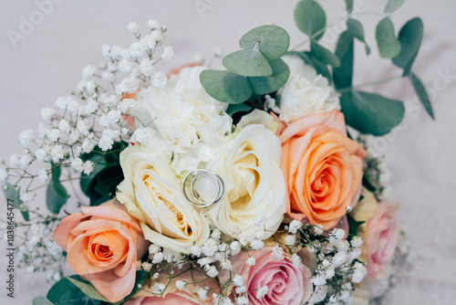 Wedding beautiful bouquet of roses in the hands of the bride, wedding rings