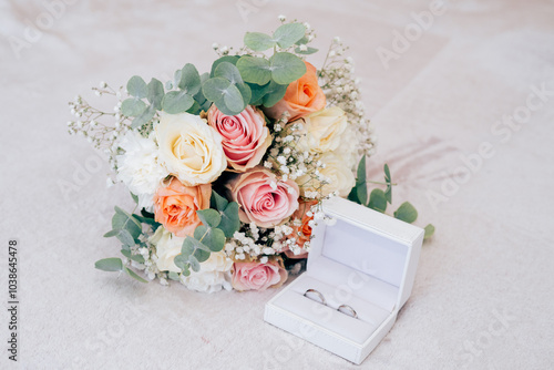 Wedding beautiful bouquet of roses in the hands of the bride, wedding rings