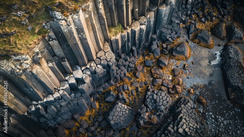 Impressive drone image showcasing geological basalt columns on a rugged coastline, showcasing Earth's natural artistry photo