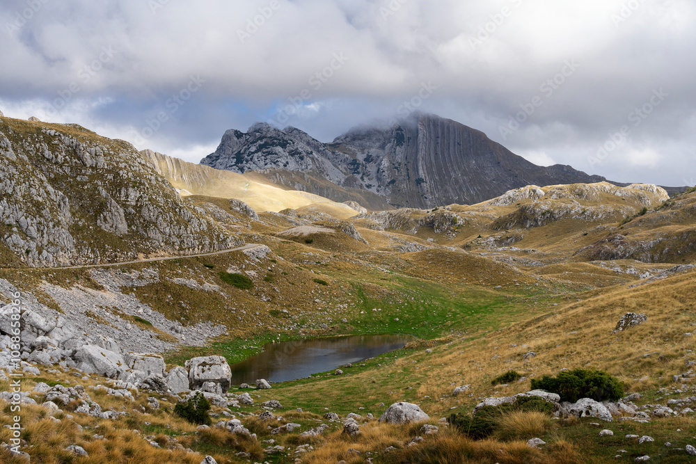 Montenegro - Durmitor National Park. Durmitor massif including peaks Gruta and Prutas and small local lake. Contrast between summer and autumn. Explore balkans Montenegro - Durmitor National Park. Durmitor massif including peaks Gruta and Prutas and small local lake. Contrast between summer and autumn. Explore balkans
