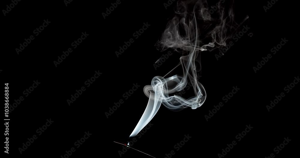 Real smoke on a black background. Thin Flexible Trickle of Real Smoke. Colorful real smoke rises up. Ideal for background or over-layer with blending mode add, screen, lighten.