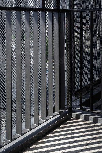 Architecture details of black steel structure railing with sunlight and shadow. 