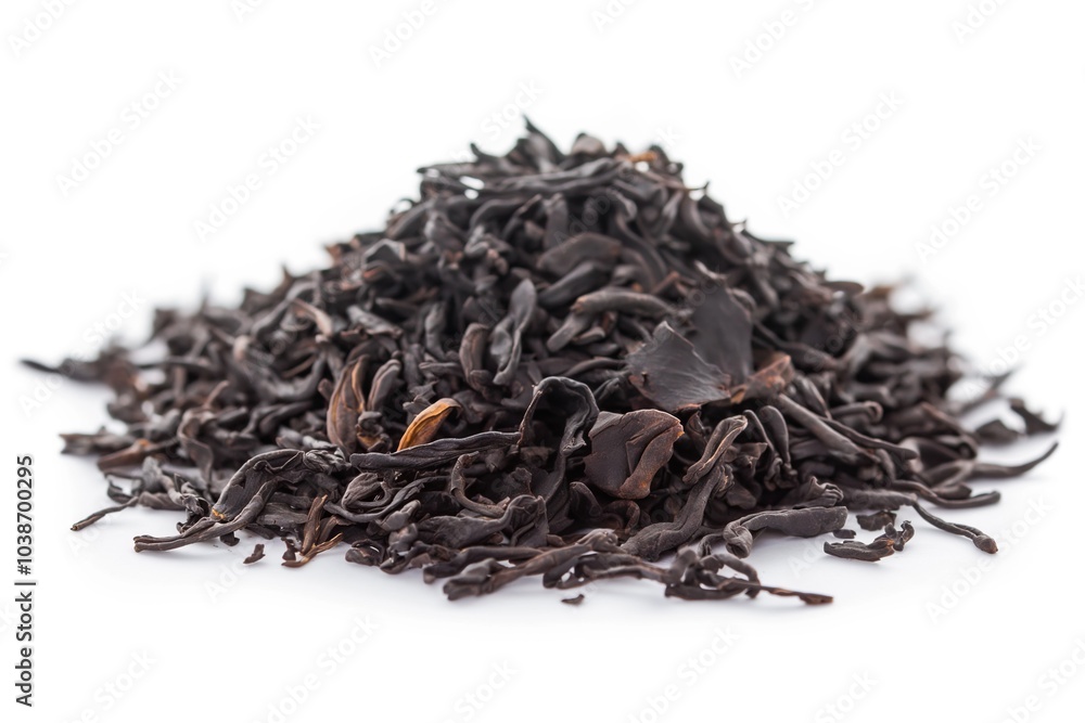 Dry black tea leaves isolated on white background. Close up. Dry black tea leaves isolated on white background. Close up.