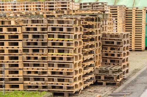 Stack of wooden pallets forming a wall in a storage area