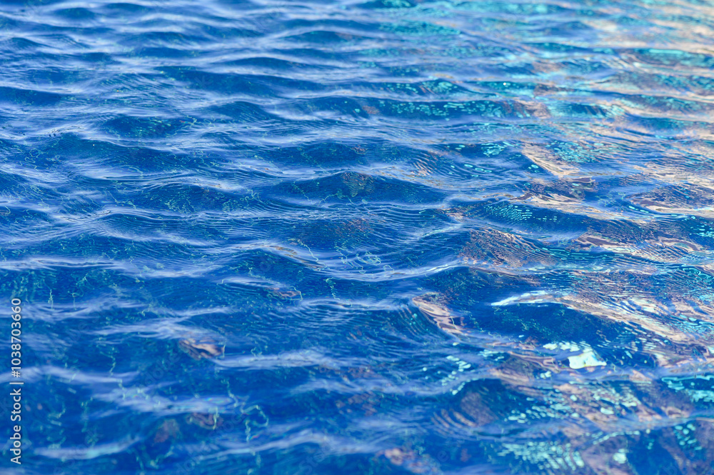 Obraz premium Glistening blue waves dance under the bright sun at a serene coastal location, reflecting vibrant hues of nature’s palette