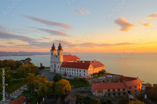 Tihany, Hungary - Aerial skyline view about the famous Benedictine Monastery of Tihany (Tihany Abbey) with beautiful colourful sky and clouds at sunrise.