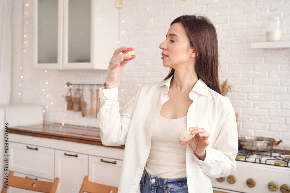Woman enjoying macarons in modern kitchen setting with soft ambient lighting. Woman enjoying macarons in modern kitchen setting with soft ambient lighting.