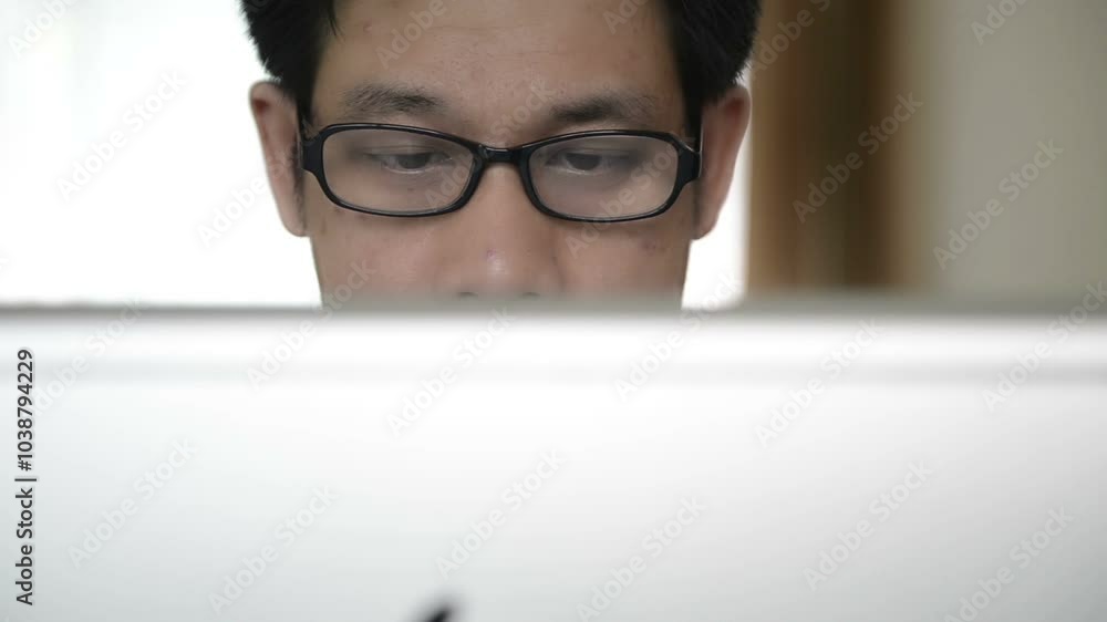A close-up view of an individual intensely focused on their laptop screen. The person's expressions suggest concentration, emphasizing the importance of digital work in our daily lives. A close-up view of an individual intensely focused on their laptop screen. The person's expressions suggest concentration, emphasizing the importance of digital work in our daily lives.