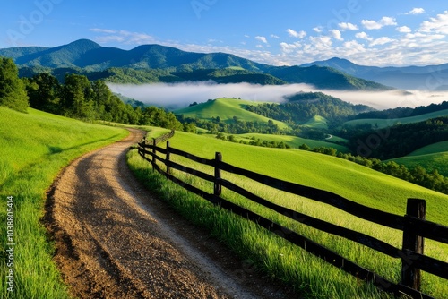 Foggy morning in the countryside, with an old wooden fence leading into the distance